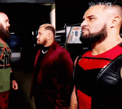 Three Men Are Standing Next To Each Other In Front Of A Gorilla Sign GIF