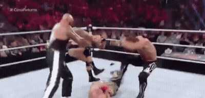Three Men Are Wrestling In A Ring With A Referee . GIF