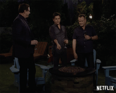 Three Men Around Fire Pit With Netflix GIF