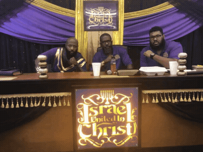 Three Men At Table With Israel United To Christ Sign GIF