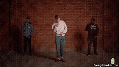 Three Men Dancing In Front Of Brick Wall GIF