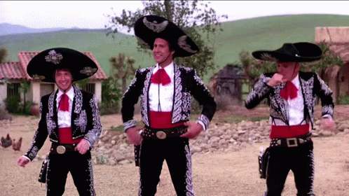 Three Men Dressed In Mariachi Outfits Are Dancing GIF