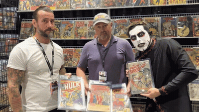Three Men Holding Hulk Comic Book GIF