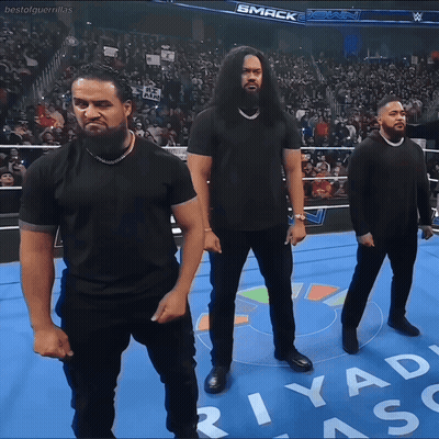 Three Men In Black Shirts On Wrestling Ring With Riyad GIF