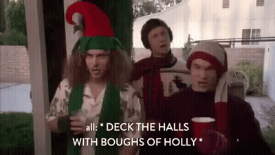 Three Men In Christmas Costumes On Porch GIF