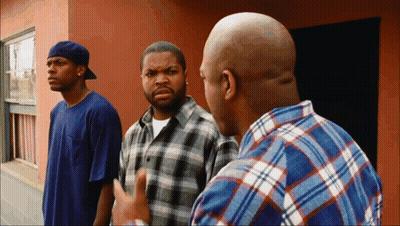 Three Men In Front Of Building One In Plaid Shirt GIF