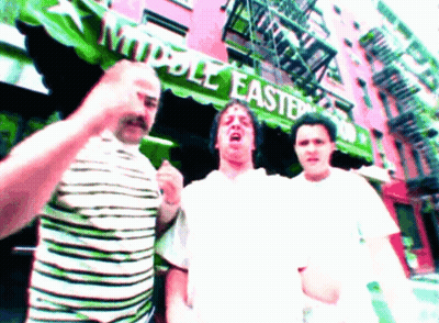Three Men In Front Of Green Awning Saying Middle East GIF