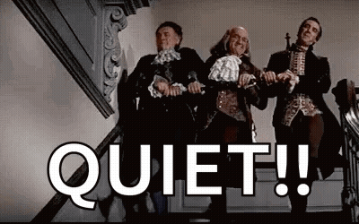 Three Men in Historical Costumes on Stairs Saying Quiet