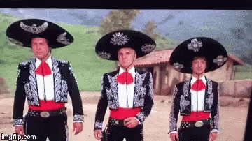 Three Men In Mariachi Costumes Standing Together GIF