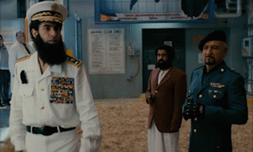 Three Men In Military Uniforms Standing In Front Of Clear Times Sign GIF
