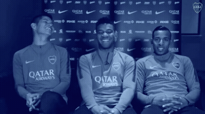 Three Men In Qatar Airways Shirts Sitting In Front Of Blue Backdrop GIF