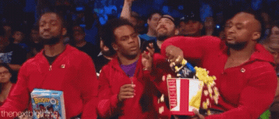 Three Men In Red Jackets Holding Popcorn GIF