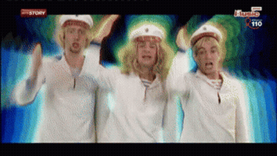 Three Men In Sailor Hats Are Dancing In Front Of A Screen That Says ' History ' On It GIF