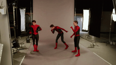 Three Men In Spider Man Costumes Are Standing In A Room GIF
