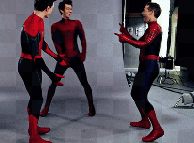 Three Men In Spiderman Costumes Are Standing In A Room GIF
