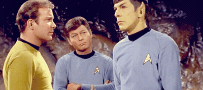 Three Men In Star Trek Uniforms Talking GIF