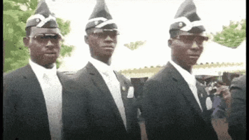 Three Men In Suits And Coffin Hats Are Standing Next To Each Other GIF