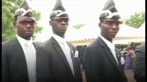 Three Men In Suits And Hats Are Standing Next To Each Other In A Row . GIF