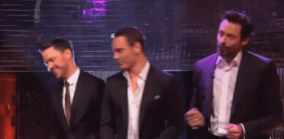 Three Men In Suits And Ties Are Dancing Together On A Stage GIF