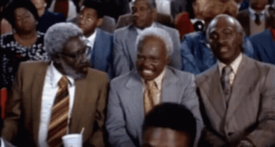 Three Men In Suits And Ties Are Sitting In A Crowd GIF