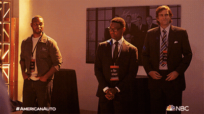 Three Men In Suits And Ties Are Standing In Front Of A Wall With A Nbc Logo GIF