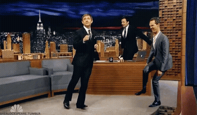 Three Men In Suits Are Dancing In Front Of Jimmy Fallon . GIF