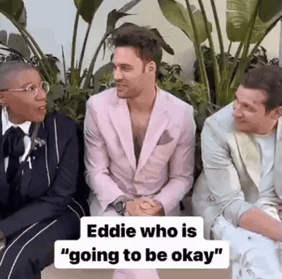Three Men In Suits Are Sitting Next To Each Other And Talking . One Of The Men Is Wearing A Pink Suit . GIF