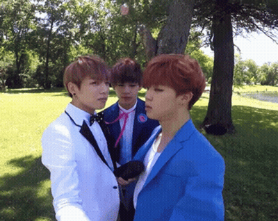 Three Men In Suits Standing In Park GIF