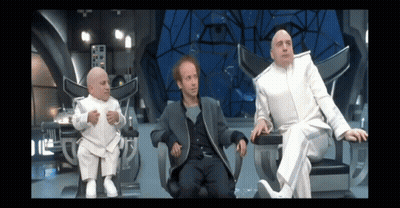 Three Men In White Suits Are Sitting In Chairs In A Futuristic Room GIF