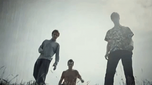 Three Men Looking Up In Field GIF