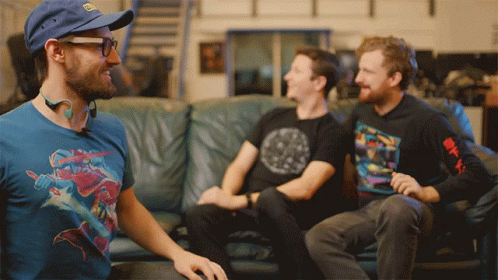 Three Men On Couch One Wearing Avengers Shirt GIF