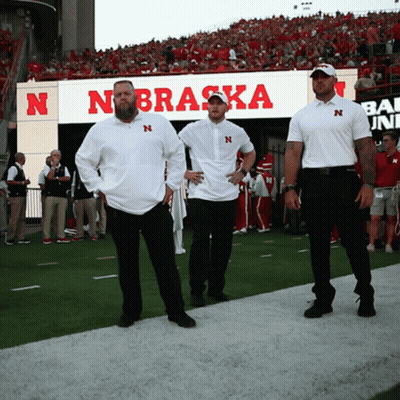Three Men On Football Field In Front Of Nebraska Sign GIF