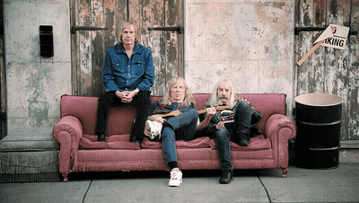 Three Men On Pink Couch In Front Of Building With No Parking Sign GIF
