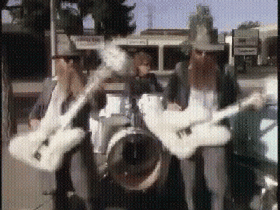 Three Men Playing Guitars And Drums In A Band GIF