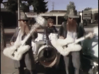 Three Men Playing Guitars And Drums In Band GIF
