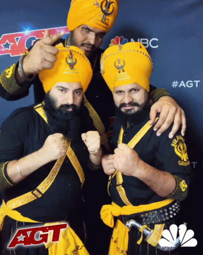Three Men Posing In Front Of AGT Sign GIF