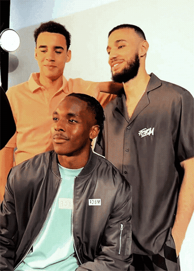 Three Men Posing One Wearing TGM Shirt GIF