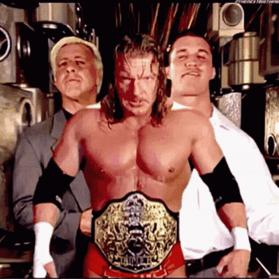 Three Men Posing With Championship Belt GIF