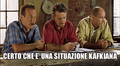 Three Men Sitting At Table Saying Certo Che E ' Una Situazione Kafkiana GIF