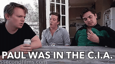 Three Men Sitting At Table Saying Paul Was In The C.I.A GIF
