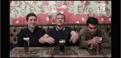 Three Men Sitting At Table With Guinness Beer GIF