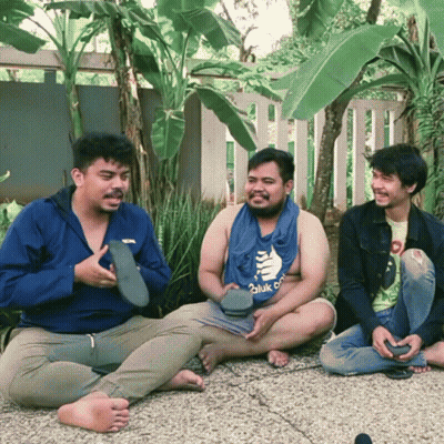 Three Men Sitting, One Wearing Hulk Shirt GIF