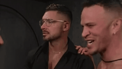 Three Men Smiling, One With Glasses And Earrings GIF