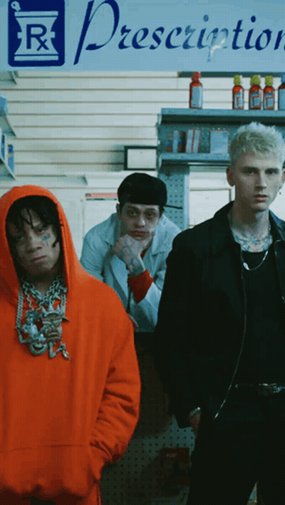 Three Men Stand In Front Of A Prescription Sign GIF