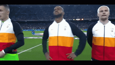 Three Men Stand On A Soccer Field Wearing Nike Jackets With The Letters G On Them GIF