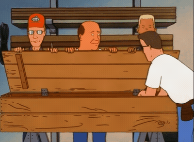 Three Men Standing Around Wooden Box With Skull Hat GIF