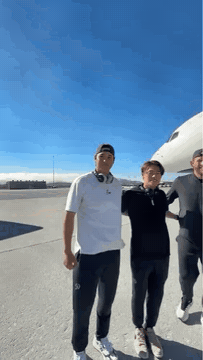 Three Men Standing Beside Airplane On Runway GIF