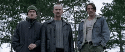 Three Men Standing in a Forest