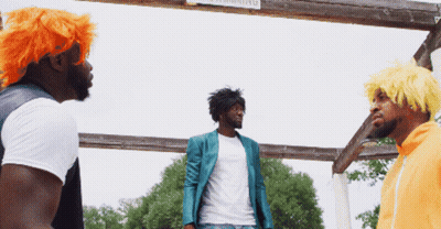 Three Men Standing In Front Of A Wooden Sign That Says Warning GIF