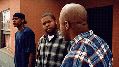 Three Men Standing In Front Of Building Talking GIF